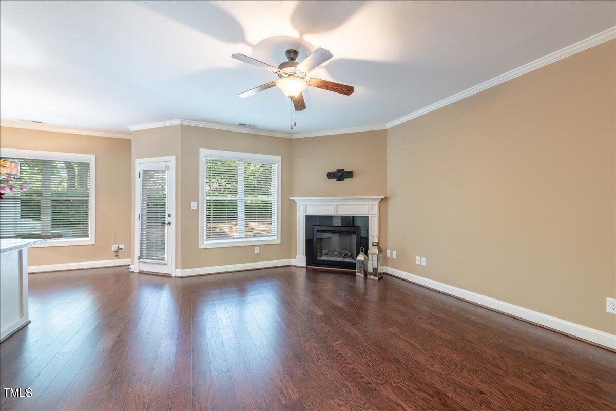 2115 Scarlet Maple Drive Raleigh, NC 27606 - Photo 9 of 32 a view of an empty room with wooden floor and a window