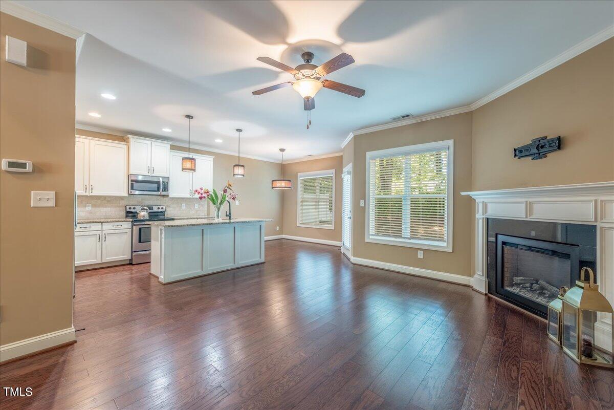 2115 Scarlet Maple Drive Raleigh, NC 27606 - Photo 10 of 32 a view of a kitchen with a stove wooden floor and a kitchen