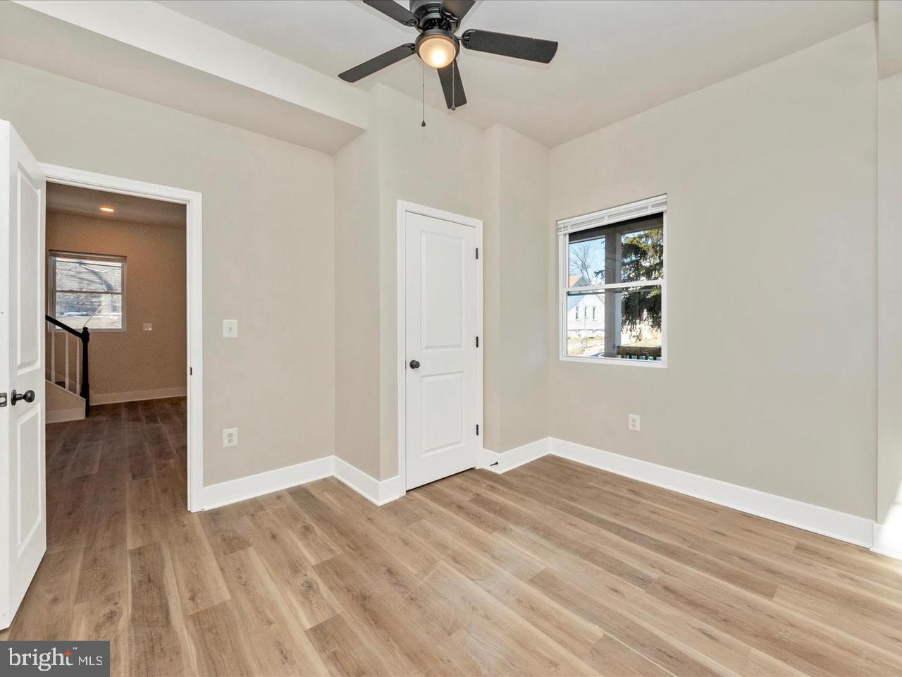 2919 Woodland Avenue Baltimore, MD 21215 - Photo 11 of 25 a view of a livingroom with wooden floor and a ceiling fan
