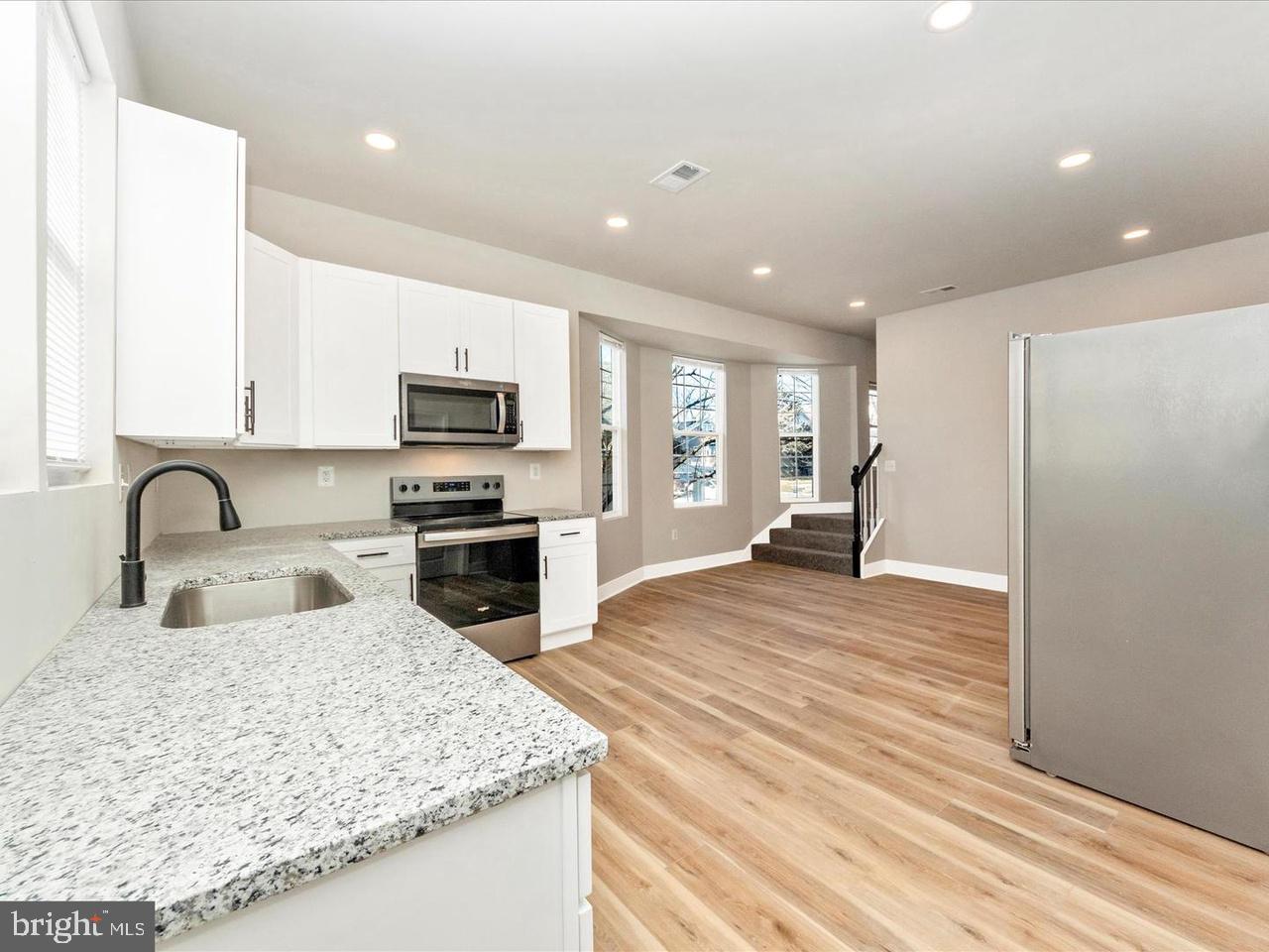 2919 Woodland Avenue Baltimore, MD 21215 - Photo 5 of 25 a kitchen with sink refrigerator and stove