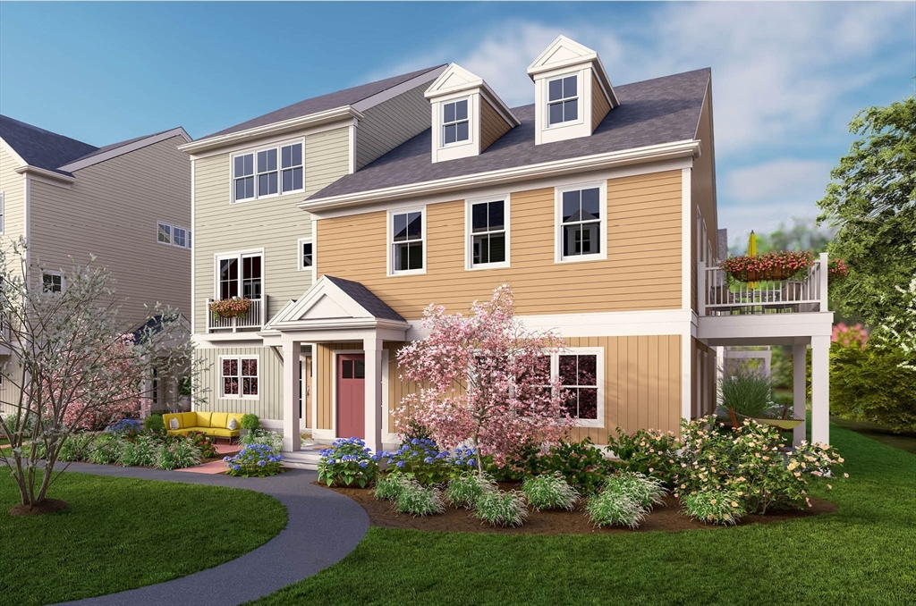 a front view of a house with a yard and potted plants