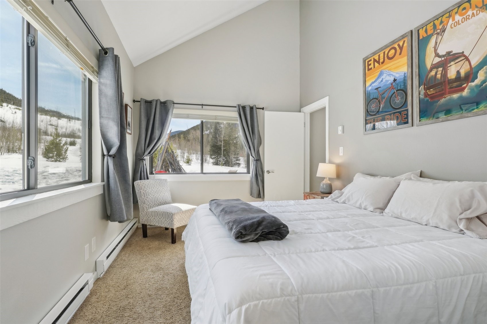 1944 Soda Ridge Road, Unit 1228 Keystone, CO 80435 - Photo 20 of 46 Carpeted bedroom featuring a baseboard radiator and vaulted ceiling