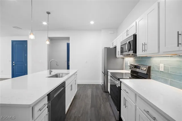 a kitchen with a sink stove and cabinets