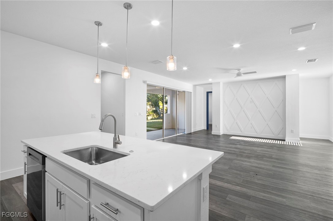 2816 Barry Road North Port, FL 34286 - Photo 12 of 36 a kitchen with a sink chandelier and wooden floor
