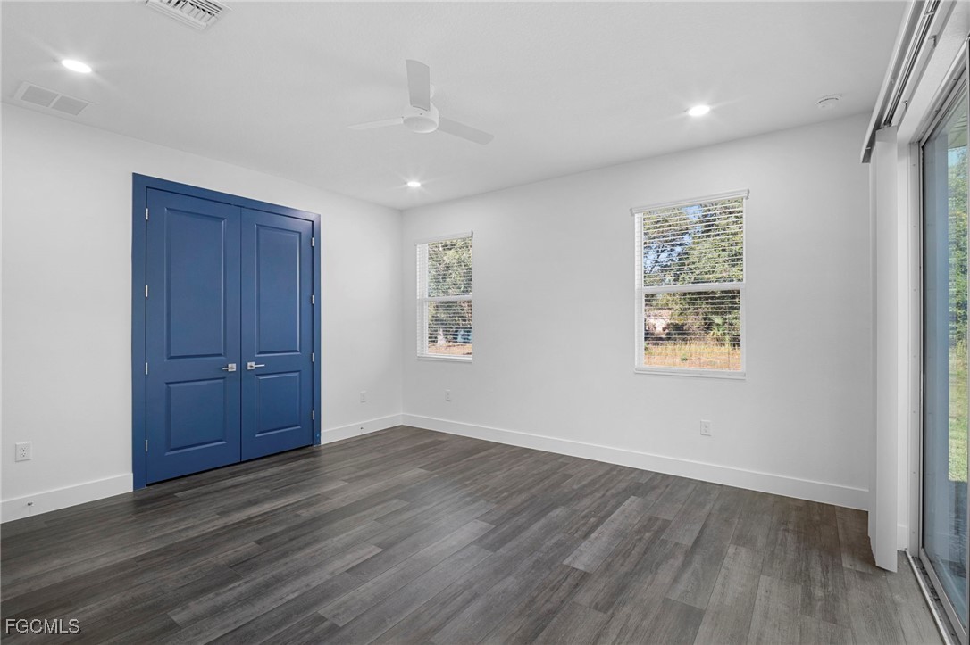2816 Barry Road North Port, FL 34286 - Photo 13 of 36 wooden floor in an empty room with a window