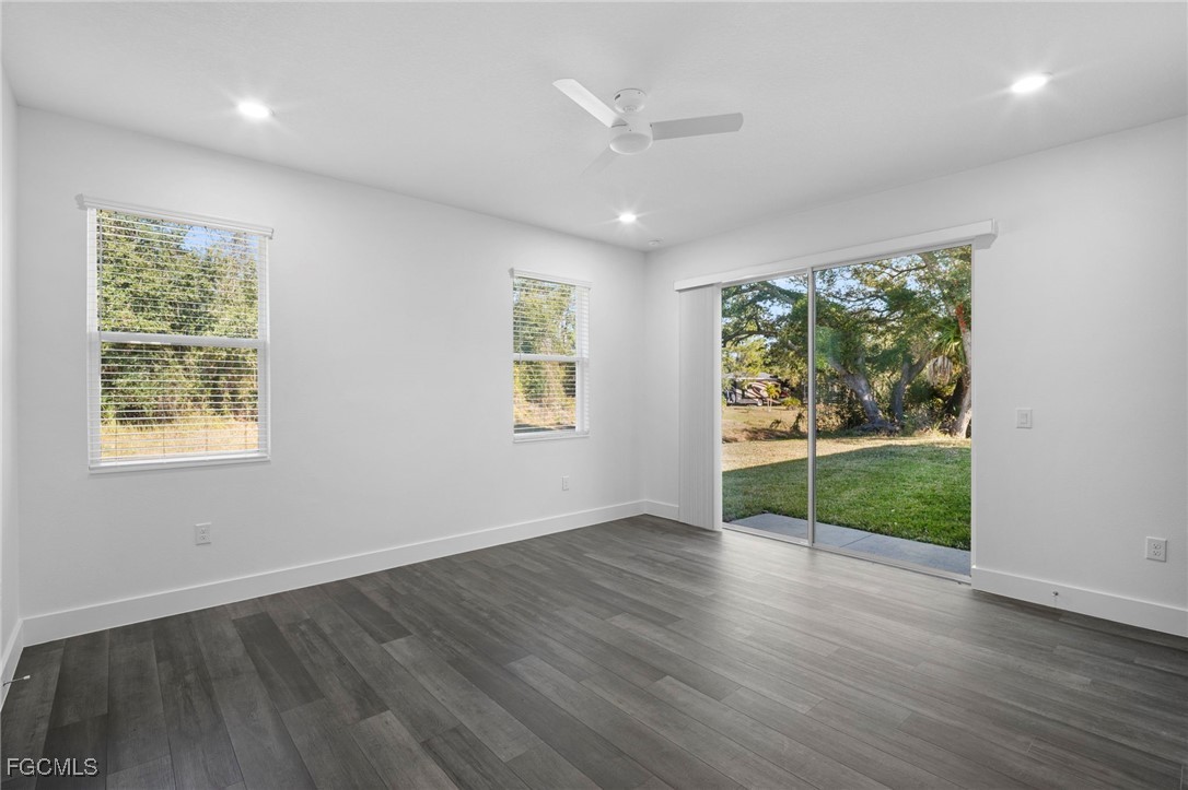 2816 Barry Road North Port, FL 34286 - Photo 14 of 36 an empty room with wooden floor and windows