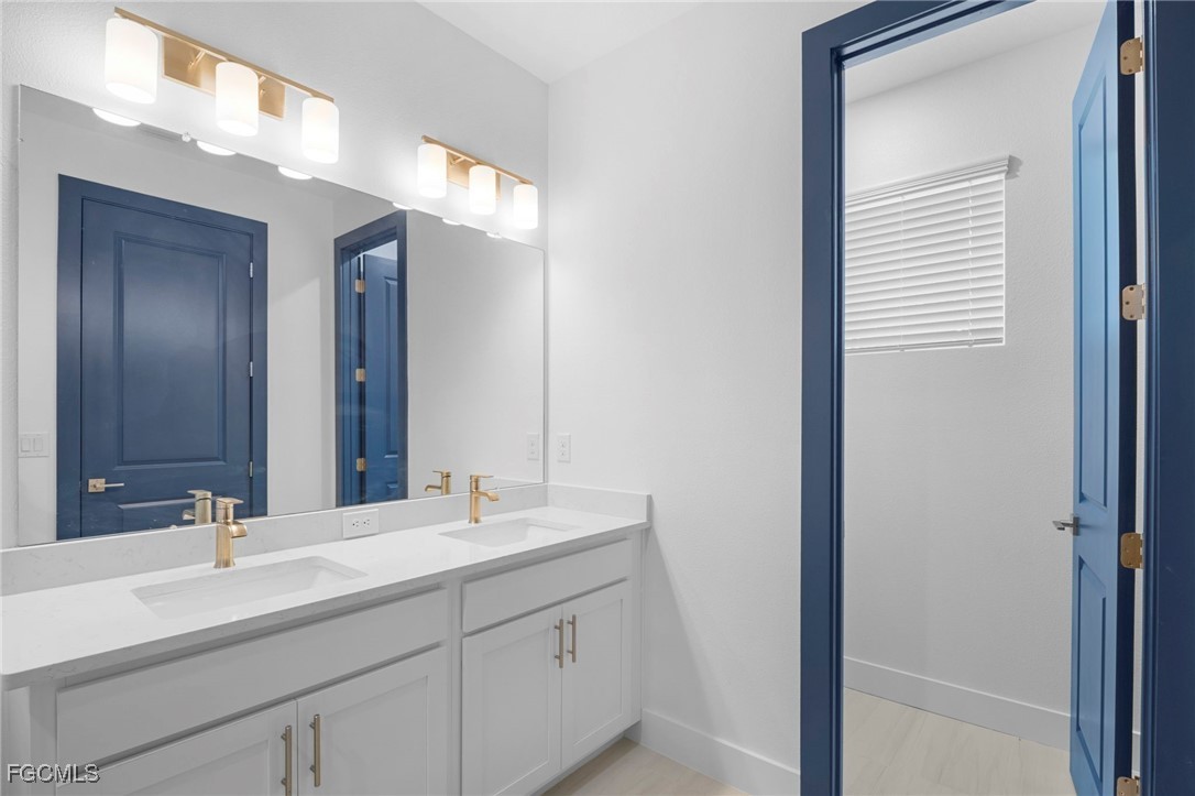 2816 Barry Road North Port, FL 34286 - Photo 19 of 36 a bathroom with a sink and a mirror