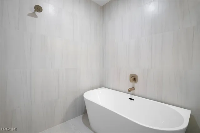 a white bath tub sitting in a bathroom