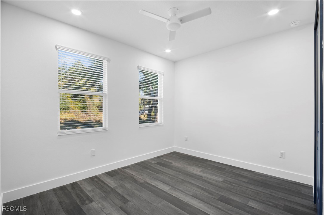 2816 Barry Road North Port, FL 34286 - Photo 24 of 36 an empty room with wooden floor and windows