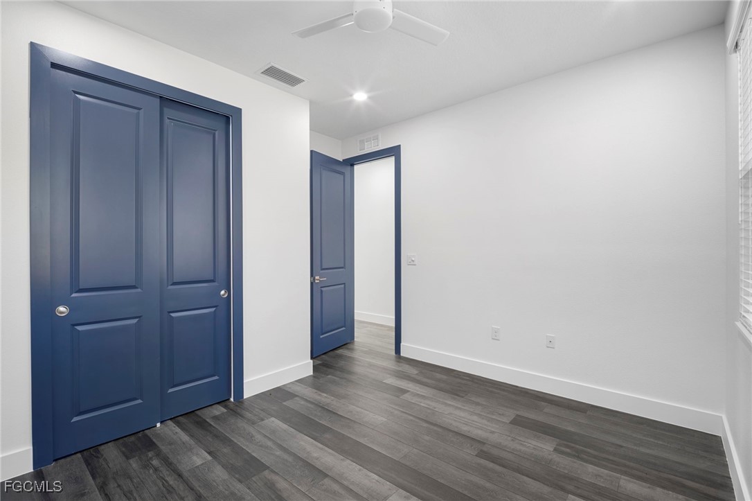 2816 Barry Road North Port, FL 34286 - Photo 25 of 36 an empty room with wooden floor and closet