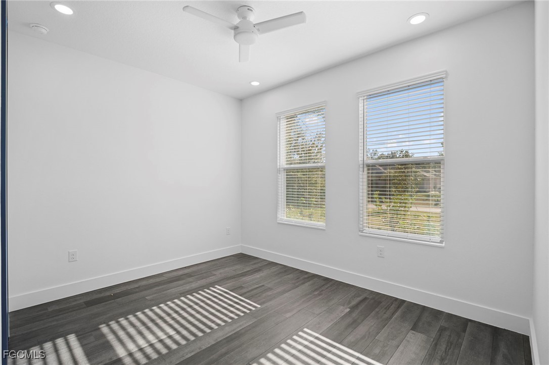 2816 Barry Road North Port, FL 34286 - Photo 27 of 36 an empty room with wooden floor cabinet and windows