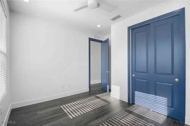 a view of wooden floor and windows in a bathroom