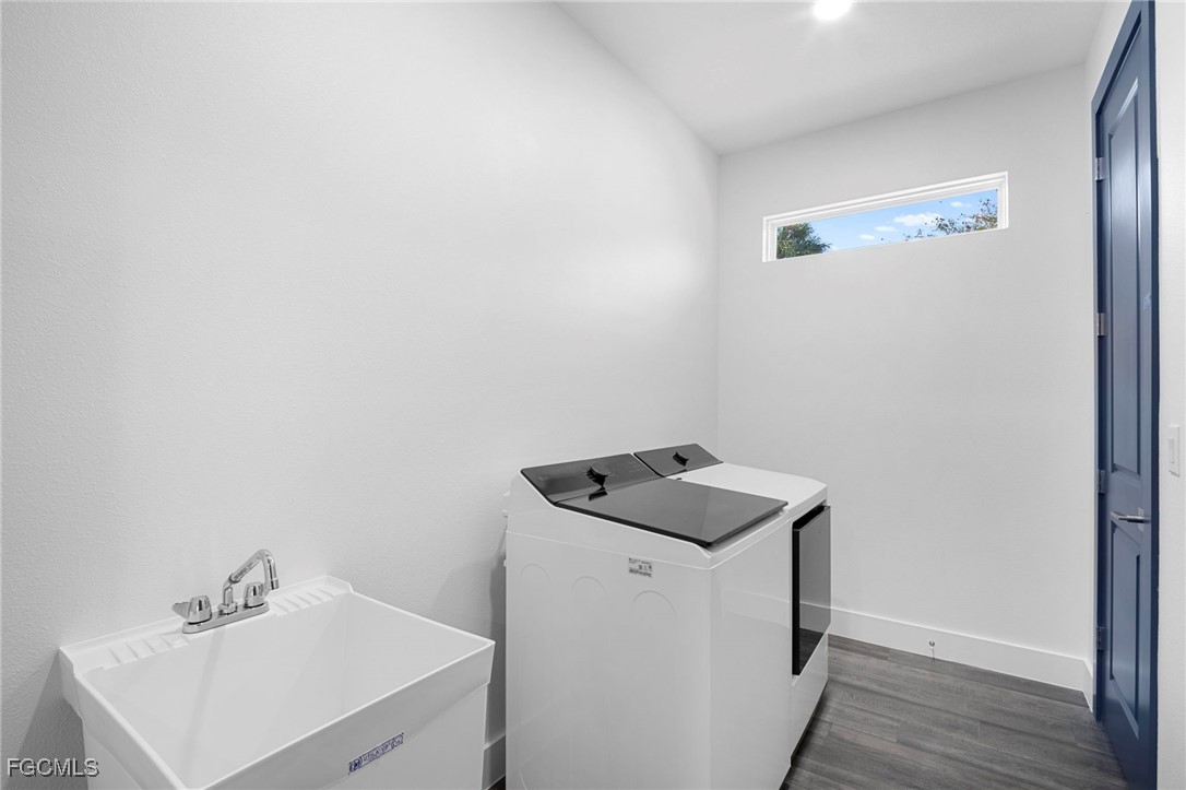 2816 Barry Road North Port, FL 34286 - Photo 31 of 36 a utility room with wooden floor washer and dryer