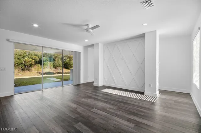 a view of room with window and wooden floor