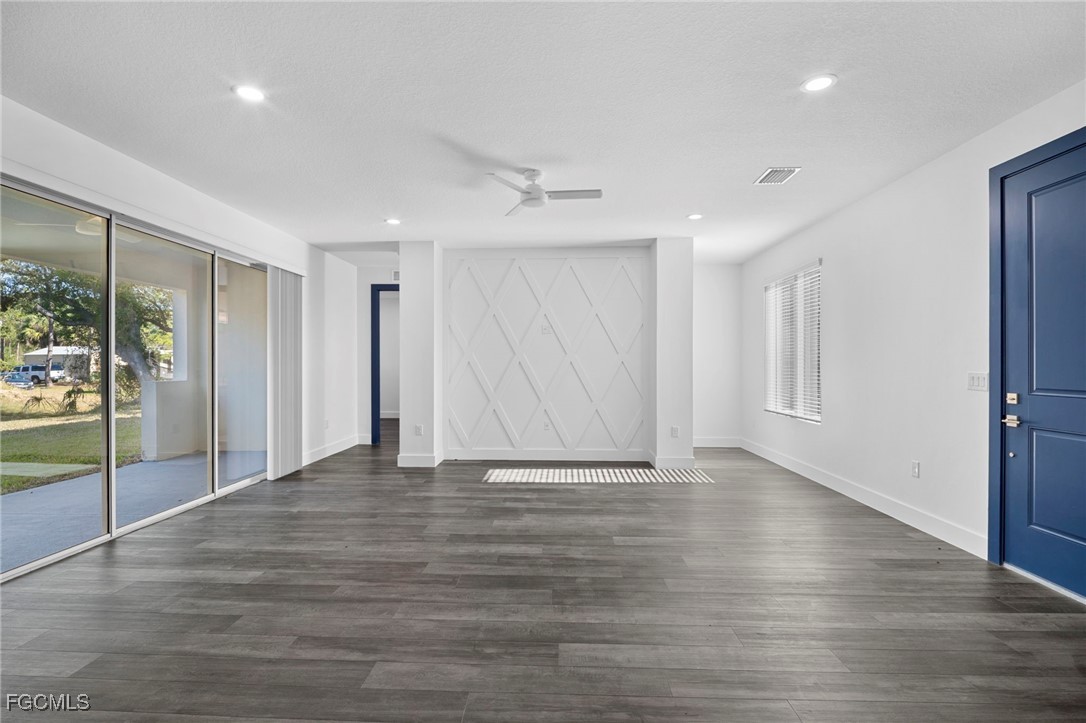 2816 Barry Road North Port, FL 34286 - Photo 5 of 36 a view of an empty room with wooden floor and a window