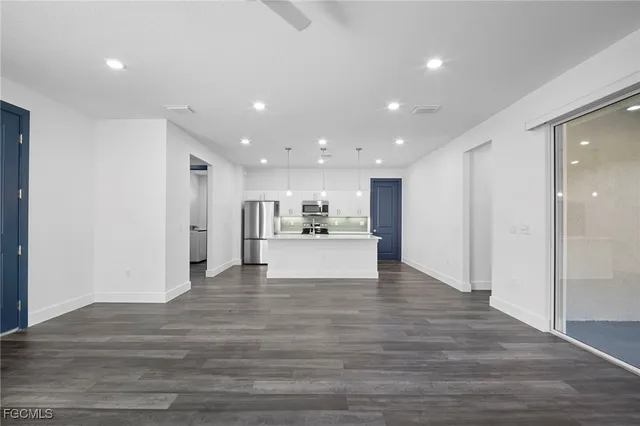 a view of a kitchen with a refrigerator and a sink