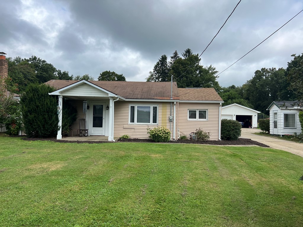 1169 Mercer Road Franklin, PA 16323 - Photo 2 of 29 a front view of a house with a garden