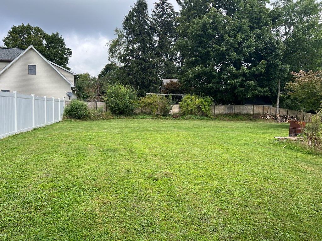 1169 Mercer Road Franklin, PA 16323 - Photo 7 of 29 a backyard of a house with plants and large trees