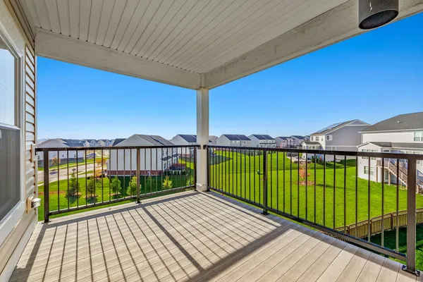 a view of balcony with wooden floor & fence