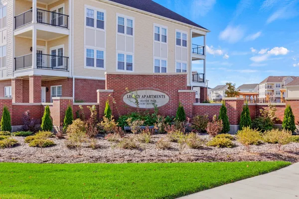 a view of a building with a garden and pathway