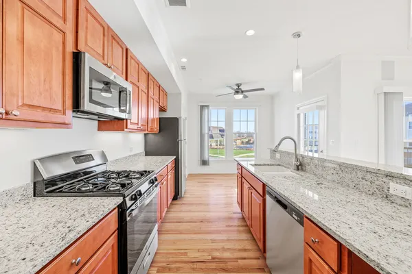 a kitchen with stainless steel appliances granite countertop a stove and a sink
