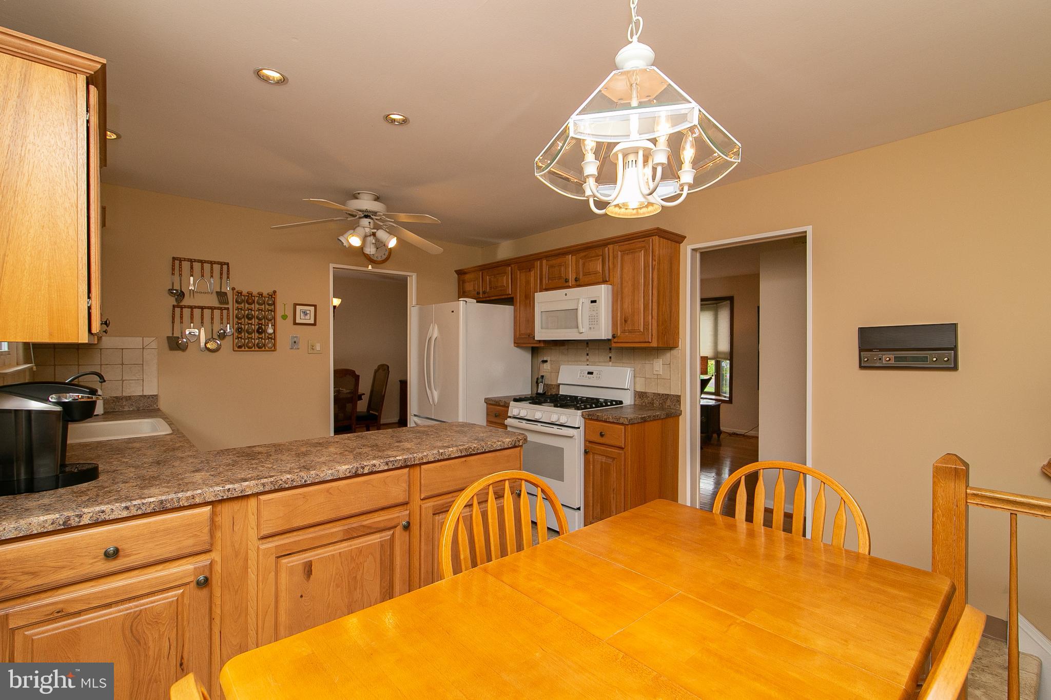 51 Rotterdam Road West Holland, PA 18966 - Photo 16 of 53 a kitchen with granite countertop a stove a sink a dining table and chairs