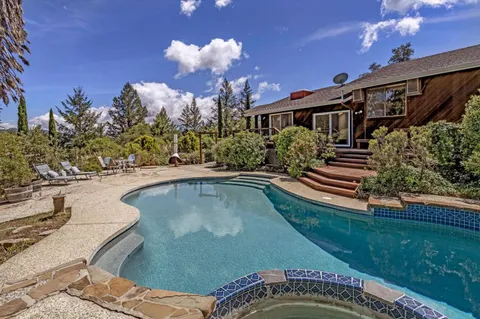 a swimming pool with outdoor seating and yard