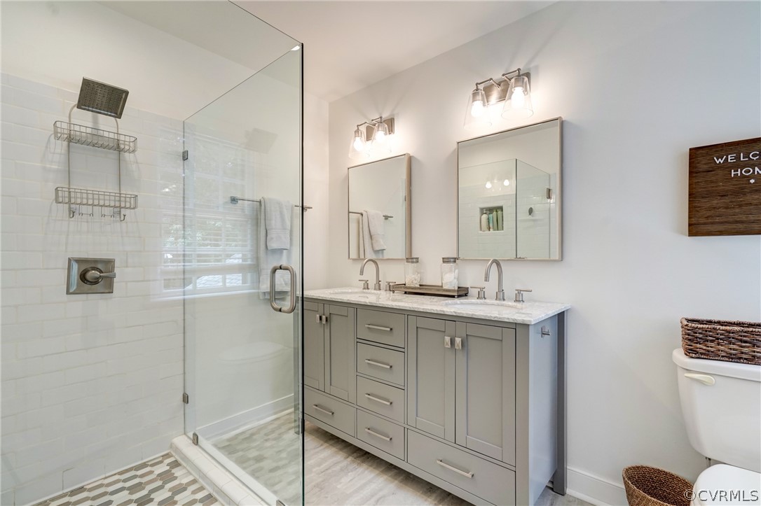 3421 Kenmore Road Richmond, VA 23225 - Photo 28 of 41 a spacious bathroom with a shower a sink and a mirror