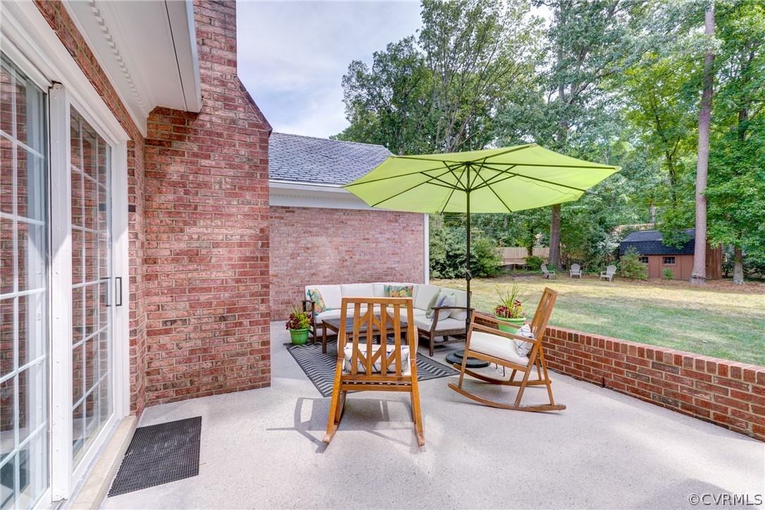 3421 Kenmore Road Richmond, VA 23225 - Photo 33 of 41 a view of a patio with a table and chairs under an umbrella