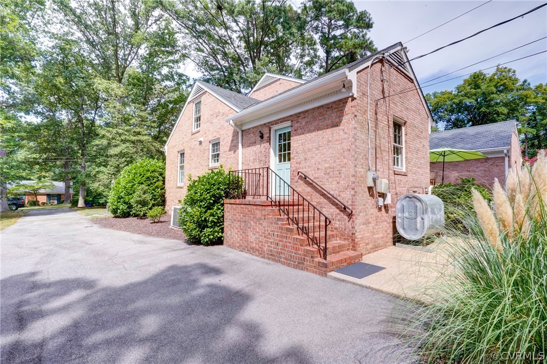 3421 Kenmore Road Richmond, VA 23225 - Photo 39 of 41 a view of a house with brick walls and potted plants