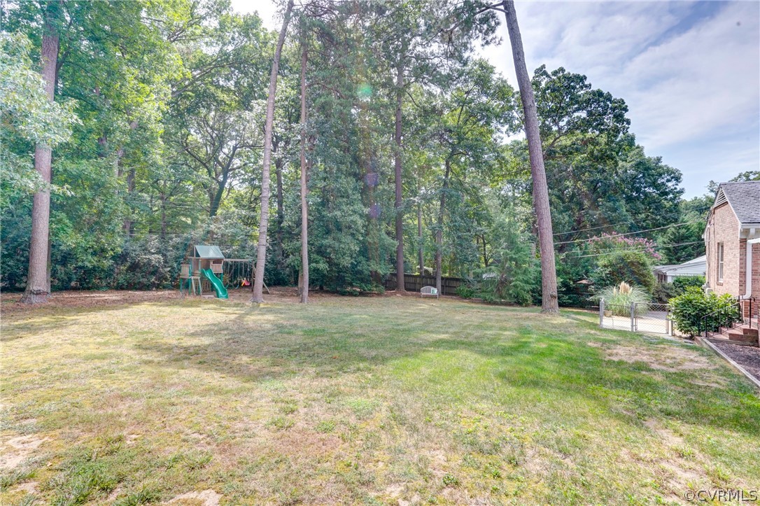 3421 Kenmore Road Richmond, VA 23225 - Photo 41 of 41 a backyard of a house with large trees and plants