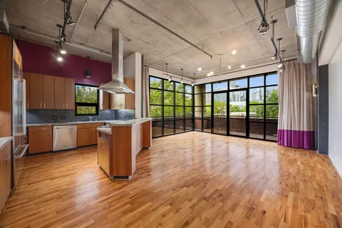 a open kitchen with stainless steel appliances granite countertop a stove and cabinets with wooden floor