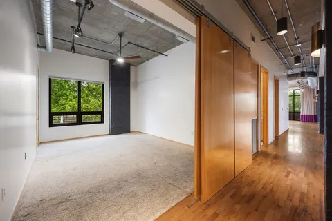 a view of hallway with wooden floor
