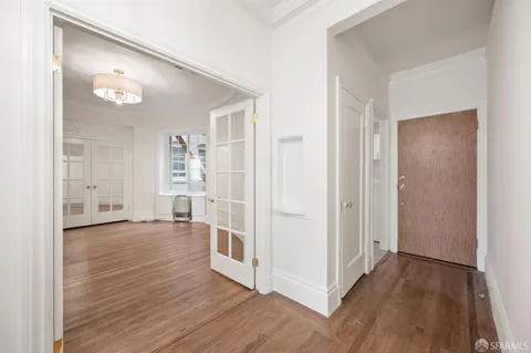a view of an empty room with cabinet and entryway