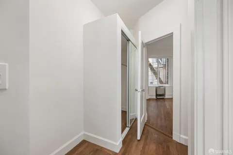 a bathroom with a toilet a sink a mirror and a window