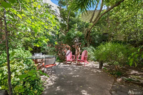 a backyard of a house with table and chairs