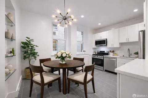 a kitchen with a table and chairs in it