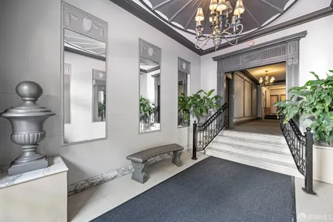 a lobby with furniture and a chandelier