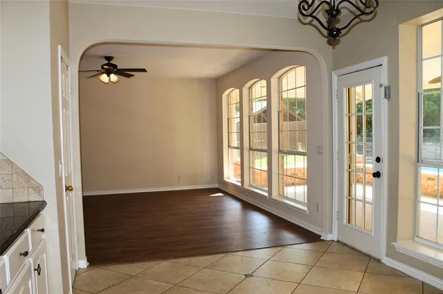 a kitchen with granite countertop white cabinets and stainless steel appliances