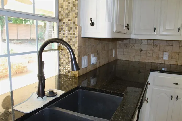 a kitchen with a stove and cabinets