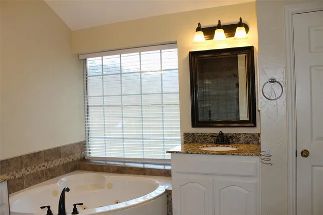 a bathroom with a bathtub and a sink