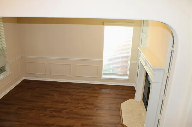 a view of a room with wooden floor and a bathroom