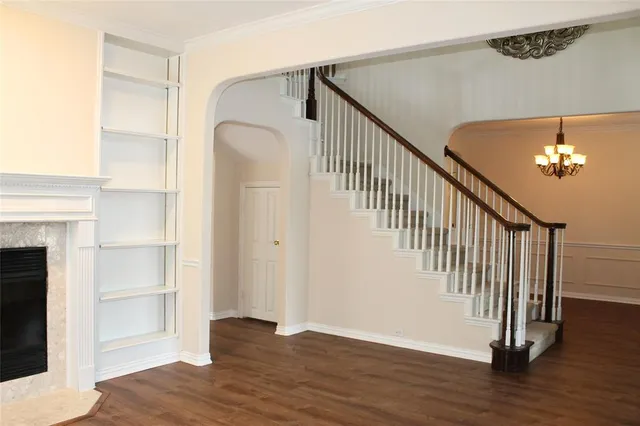 a view of a hallway with wooden floor and staircase