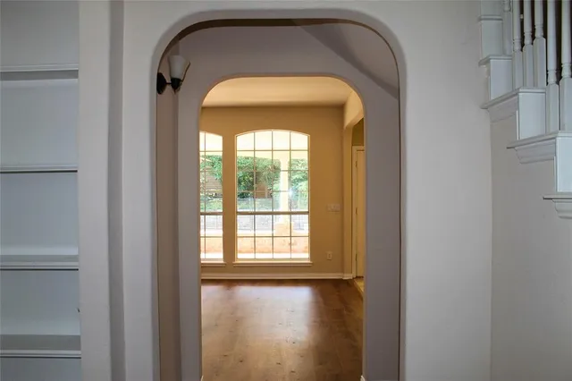 a view of a hallway with wooden floor and a fireplace