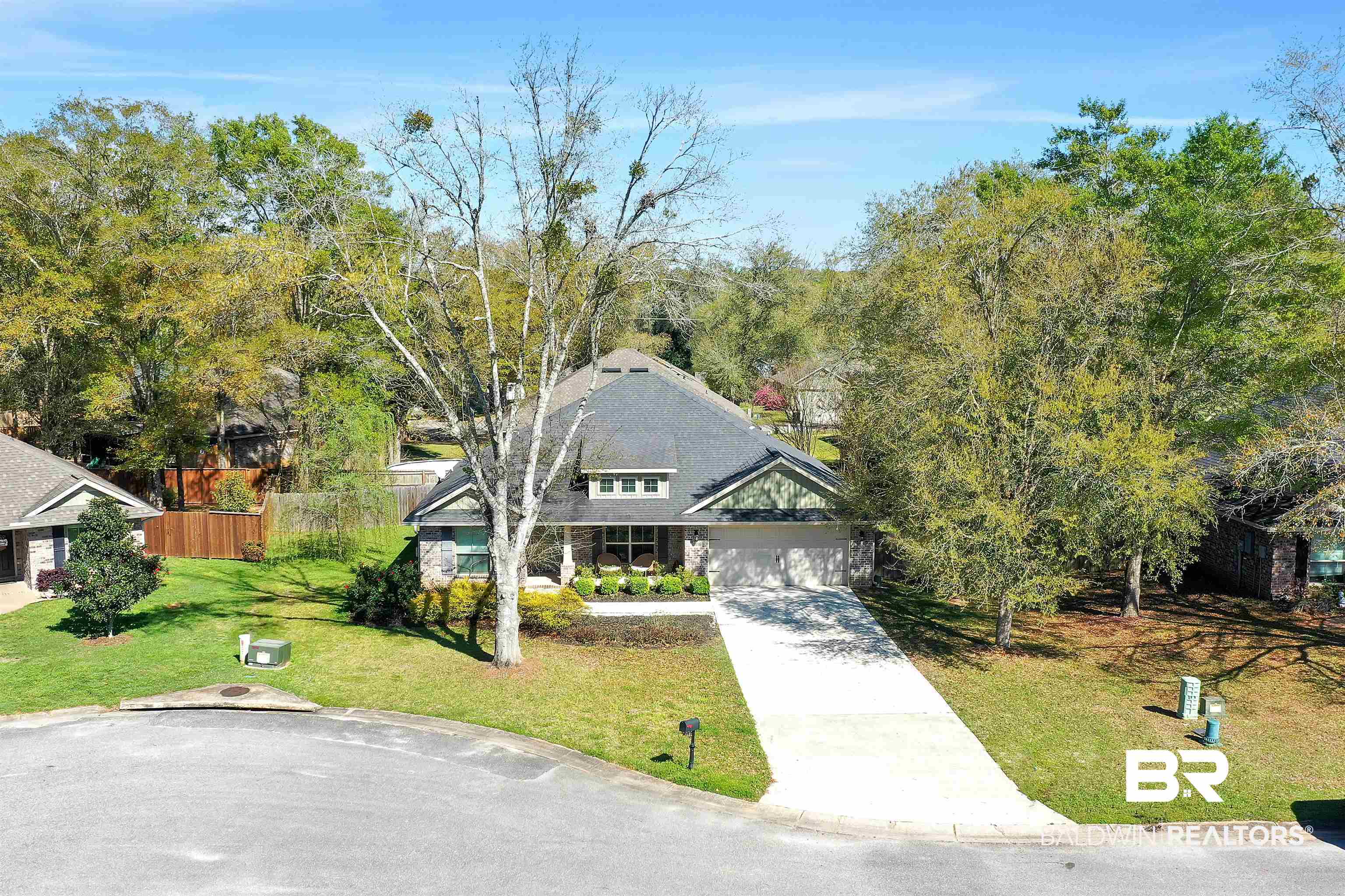 13166 Hulbert Court Foley, AL 36535 - Photo 4 of 27 View of front of house with concrete driveway, a garage, fence, and a front lawn