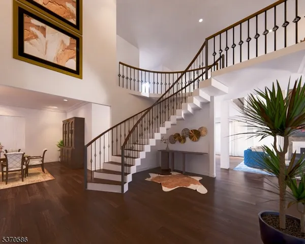 a bathroom with a granite countertop toilet a sink and a mirror