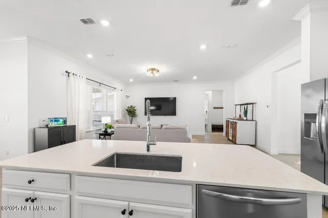 a bedroom with a large bed and a tv on the dresser