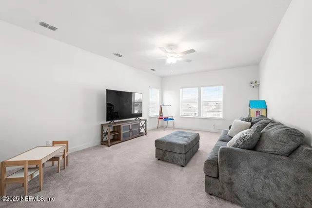 a view of a patio with table and chairs floor to ceiling window with wooden floor