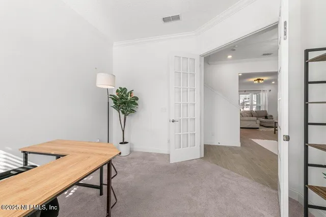 a kitchen with stainless steel appliances a stove a sink a microwave a dining table and chairs