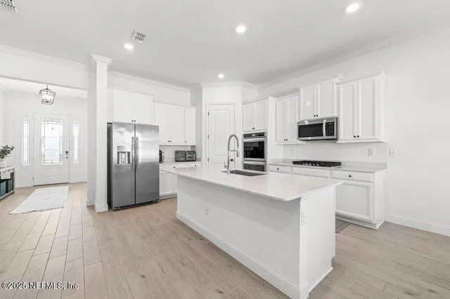 a kitchen with a sink and a refrigerator